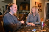 Lemoore's Katie Lowe laughs in the kitchen with mom Sandi. Katie came home for a few weeks from her Peace Corps job in Tonga where she teaches English as a Second Language.